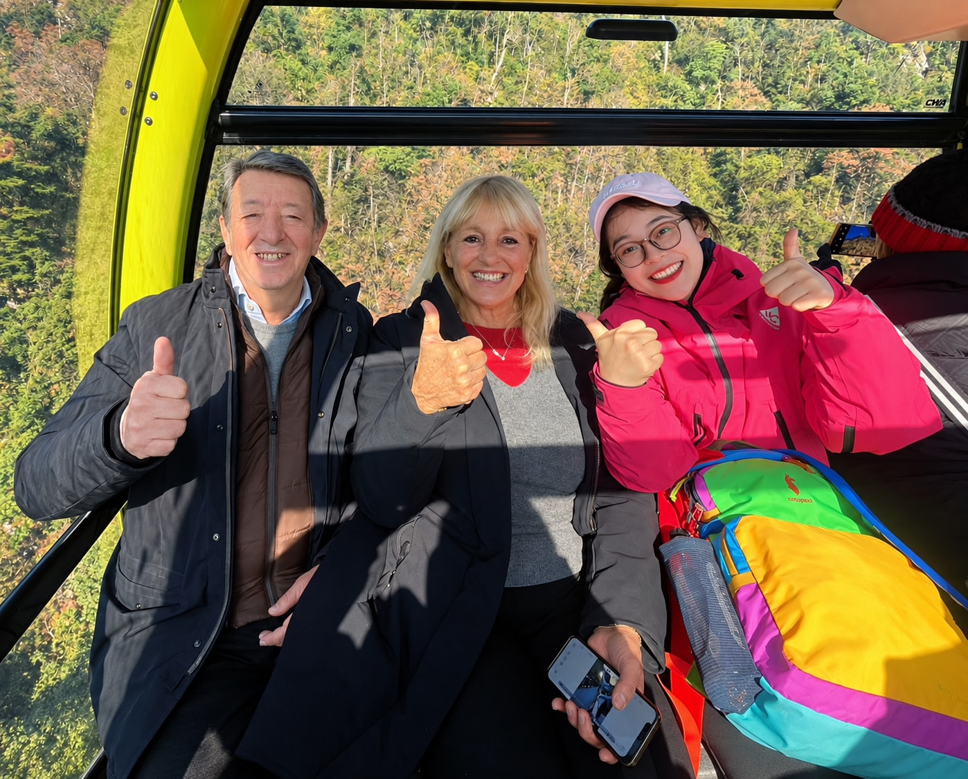 A licensed guide with travellers on a cable car in Guizhou