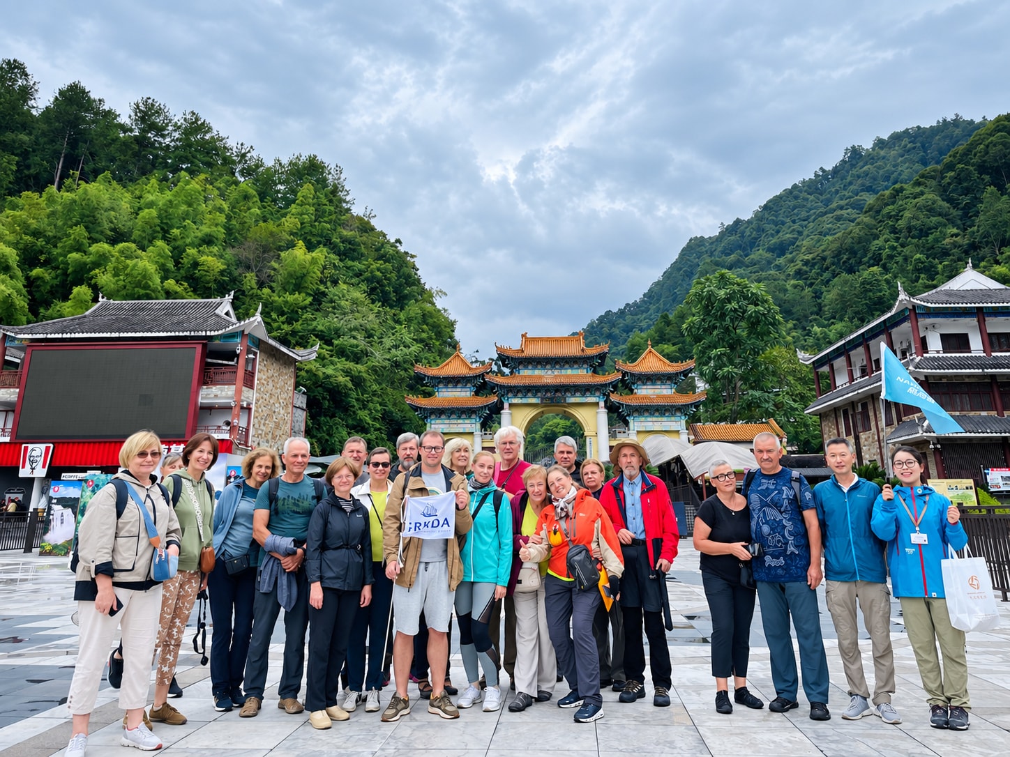 A licensed guide with a group of travellers at a mountain gate in China